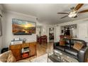 Open concept living room showcasing a large TV, wood floors, and access to dining area at 4850 E Desert Cove Ave # 227, Scottsdale, AZ 85254