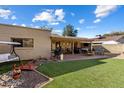 Expansive backyard with covered patio, hot tub, outdoor furniture, and manicured lawn, perfect for entertaining at 520 W Port Royale Ln, Phoenix, AZ 85023