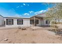 Exterior daytime shot of a home with an awning and desert landscaping at 53040 W Whirly Bird Rd, Maricopa, AZ 85139