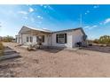 Exterior shot of a desert home with an attached garage and awning at 53040 W Whirly Bird Rd, Maricopa, AZ 85139