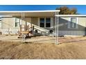 Inviting single-story home with a covered porch and outdoor seating area at 538 S 98Th St, Mesa, AZ 85208