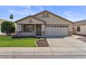 Charming one-story home with a two-car garage, manicured lawn, and welcoming curb appeal at 6121 S Ruby Dr, Chandler, AZ 85249