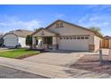Beautiful one-story home boasts a two-car garage, well-kept lawn, and an inviting facade at 6121 S Ruby Dr, Chandler, AZ 85249