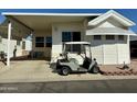 Charming home featuring a covered carport and a golf cart parked in front, perfect for leisure and convenience at 7750 E Broadway Rd # 814, Mesa, AZ 85208