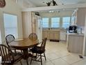 A kitchen featuring ample counter space, appliances, and a breakfast nook set with wooden table and four chairs at 7750 E Broadway Rd # 814, Mesa, AZ 85208