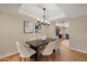 Inviting dining area with stylish furniture, a modern light fixture, and a view of the adjacent living spaces at 12222 N Paradise Village S Pkwy # 224, Phoenix, AZ 85032