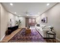 Bright living room featuring a large rug, comfortable seating, and sliding door access to a balcony at 12222 N Paradise Village S Pkwy # 224, Phoenix, AZ 85032