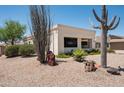 Well-maintained home featuring low-water landscaping, desert plants, and a red-tiled roof at 12423 W Morning Dove Dr, Sun City West, AZ 85375