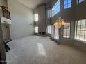 Spacious living room featuring large windows, high ceilings, neutral colors, and a fireplace at 1302 E Tierra Buena Ln, Phoenix, AZ 85022