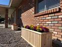 Up-close view of charming flower boxes adding character to the brick home's exterior at 1322 S Oracle --, Mesa, AZ 85204