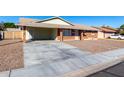 A single-story brick home with a covered carport with gravel landscaping and a spacious driveway at 1322 S Oracle --, Mesa, AZ 85204