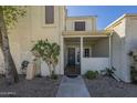Home exterior featuring stucco, gated courtyard, desert landscaping, and covered porch at 15801 N 29Th St # 11, Phoenix, AZ 85032