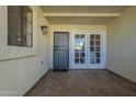 Covered patio featuring tiled flooring, metal security door, and paneled glass doors at 15801 N 29Th St # 11, Phoenix, AZ 85032