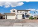 Charming stucco home with a three-car garage, complemented by stone accents and tile roofing at 16918 W Statler St, Surprise, AZ 85388