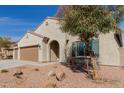 Beautiful single-story home with a well-manicured yard, three-car garage, and a cozy entryway at 17462 W Straight Arrow Ln, Surprise, AZ 85387