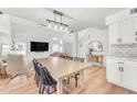 Stylish dining room with a modern light fixture and open to the living area at 17473 N 167Th Dr, Surprise, AZ 85374
