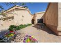 Private outdoor courtyard area with brick pavers, seating area, and lush landscaping at 19427 N 84Th Ave, Peoria, AZ 85382
