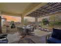Inviting covered patio with comfortable seating and a built-in barbeque, perfect for outdoor entertaining at 20044 N London Bridge Dr, Surprise, AZ 85387