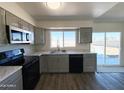 A well-lit kitchen features stainless steel appliances and countertops with a view to the backyard at 2018 W Western Dr, Chandler, AZ 85224