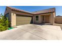 Inviting exterior view displaying desert landscaping, a two-car garage, and a covered entryway at 2021 E Velvet Pl, Casa Grande, AZ 85122