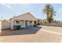 Quaint single-story house with a covered front porch and mature palm trees in the neighborhood at 2033 W Adams St, Phoenix, AZ 85009