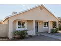 Attractive single-story home showcasing a covered porch and well-maintained landscaping at 2033 W Adams St, Phoenix, AZ 85009