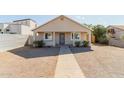 Lovely single-story home with a low-maintenance desert landscape in the front yard at 2033 W Adams St, Phoenix, AZ 85009