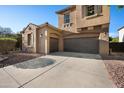 Home featuring a long driveway leading to a spacious three-car garage at 2134 E Honeysuckle Pl, Chandler, AZ 85286