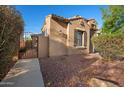 A desert landscaped yard with a wall and a gated entrance, adjacent to the house at 2134 E Honeysuckle Pl, Chandler, AZ 85286