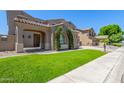 Inviting home with porte-cochere, manicured lawn, desert landscaping, and neutral paint at 2453 E Ebony Dr, Chandler, AZ 85286