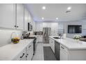 Modern kitchen features sleek white cabinetry, stainless steel appliances, and ample countertop space at 25658 N 140Th Ln, Surprise, AZ 85387