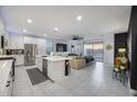Bright open-concept living space with a modern kitchen, comfortable seating, and outdoor views at 25658 N 140Th Ln, Surprise, AZ 85387
