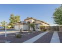 Well maintained home with stucco exterior, a tile roof, three car garage and beautiful desert landscaping at 2621 S 157Th Dr, Goodyear, AZ 85338