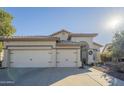Charming home with stucco exterior, tile roof, a three car garage and well-manicured desert landscaping at 2621 S 157Th Dr, Goodyear, AZ 85338