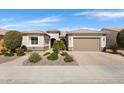Inviting single-story home showcases a two-car garage, desert landscaping, and a covered entrance for added curb appeal at 26616 W Quail Ave, Buckeye, AZ 85396