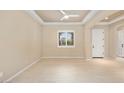 Bright living room with neutral paint, recessed lighting, tile flooring, and large window for natural light at 26616 W Quail Ave, Buckeye, AZ 85396