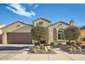 Inviting single-story stucco home with a two-car garage, desert landscaping, and a brick-paved driveway at 26828 W Piute Ave, Buckeye, AZ 85396