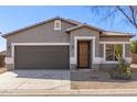 Inviting home exterior with a neutral color scheme, two car garage, and a welcoming front entrance at 28933 N Saddle Way, San Tan Valley, AZ 85143