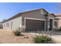 Home exterior featuring desert landscaping, neutral colors, and an attached two-car garage at 28933 N Saddle Way, San Tan Valley, AZ 85143