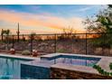 Relaxing hot tub with custom stonework and a beautiful view of the Arizona sunset at 31106 N 138Th Ave, Peoria, AZ 85383