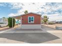 Charming home featuring a covered carport, easy access to the front door, and a clean and well-maintained yard at 320 E Mckellips Rd # 166, Mesa, AZ 85201