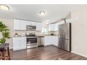 Modern kitchen with white cabinets, stainless steel appliances, and hardwood floors at 320 E Mckellips Rd # 166, Mesa, AZ 85201