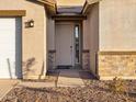 Inviting covered front porch with stone accents and a charming front door at 3598 E Alexander Dr, San Tan Valley, AZ 85143