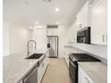 Bright kitchen featuring white cabinets, stainless steel appliances, and granite countertops at 3598 E Alexander Dr, San Tan Valley, AZ 85143