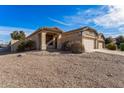 Charming single-story home with desert landscaping and a two-car garage on a sunny day at 44922 W Alamendras St, Maricopa, AZ 85139