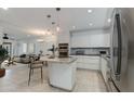 Modern kitchen featuring an island, stainless steel appliances, and sleek white cabinetry at 5333 N Las Casitas Pl, Phoenix, AZ 85016