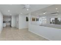 Open living room with bright white walls, tile floors, and split-level layout at 5333 N Las Casitas Pl, Phoenix, AZ 85016