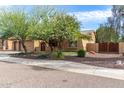 Charming home featuring a three car garage, desert landscaping, and a cozy front porch at 5523 W Yearling Rd, Phoenix, AZ 85083