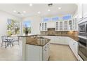 Spacious kitchen featuring ample counter space, white cabinetry, and stainless steel appliances at 5892 E Evening Glow Dr, Scottsdale, AZ 85266