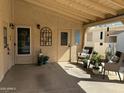 Inviting covered patio with comfortable seating, potted plants, and access doors at 6161 S Pinehurst Dr, Chandler, AZ 85249